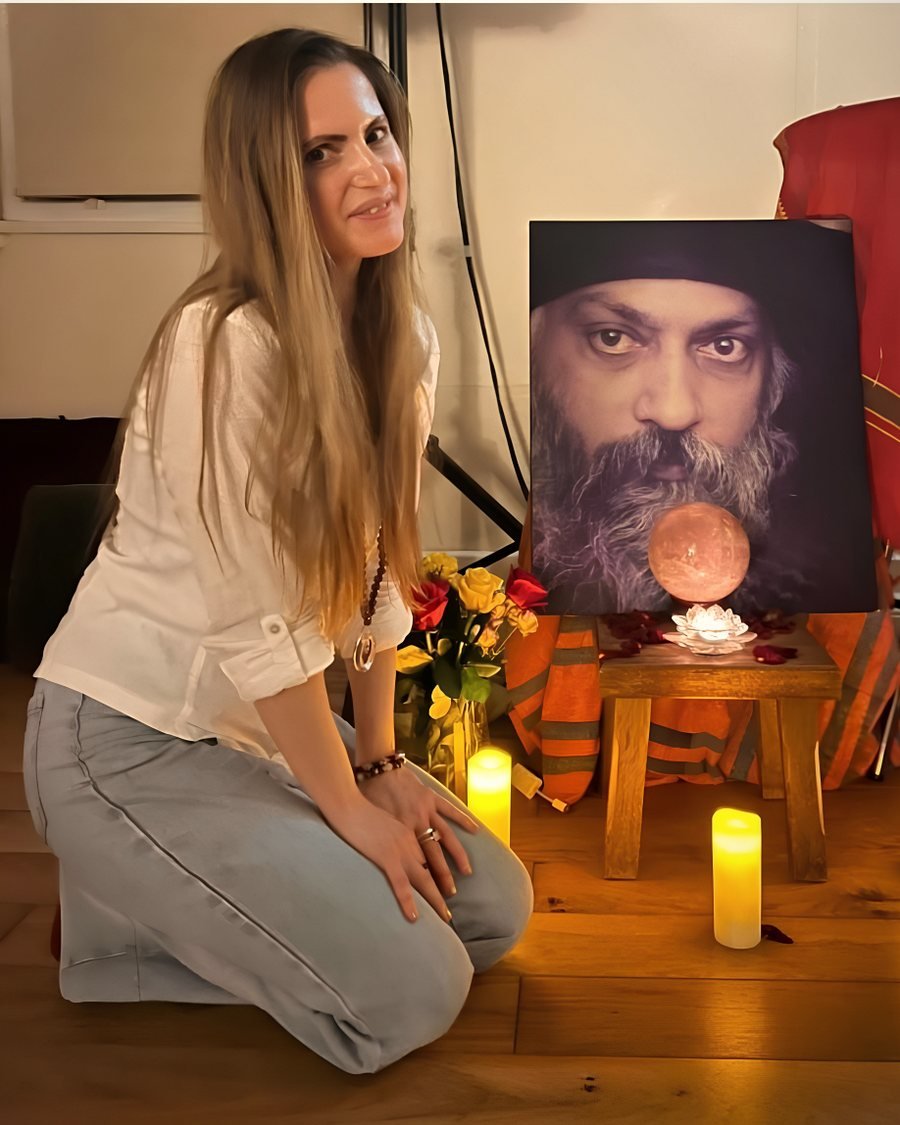 Joanna at her altar, with candles and a rose quartz sphere